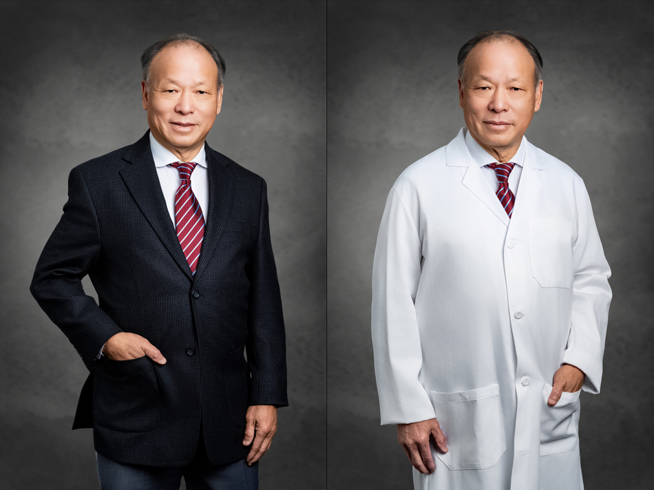 Male physician photographed in a charcoal suit with a red tie and in a white coat by Marc Weisberg for a professional headshot session